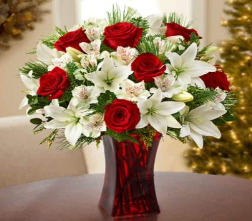 White lilies look amazing with red roses. Image Source: Vienna Florist