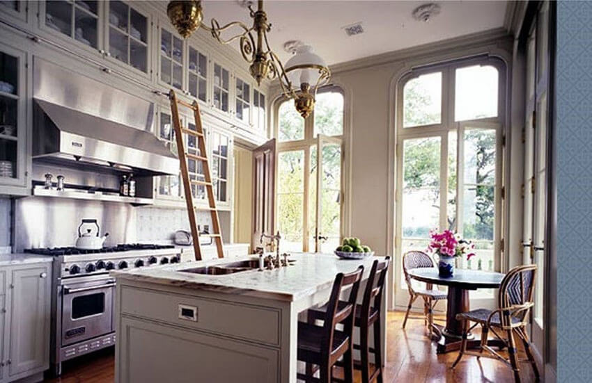 A rolling ladder can help you get to vertical storage in a small kitchen.